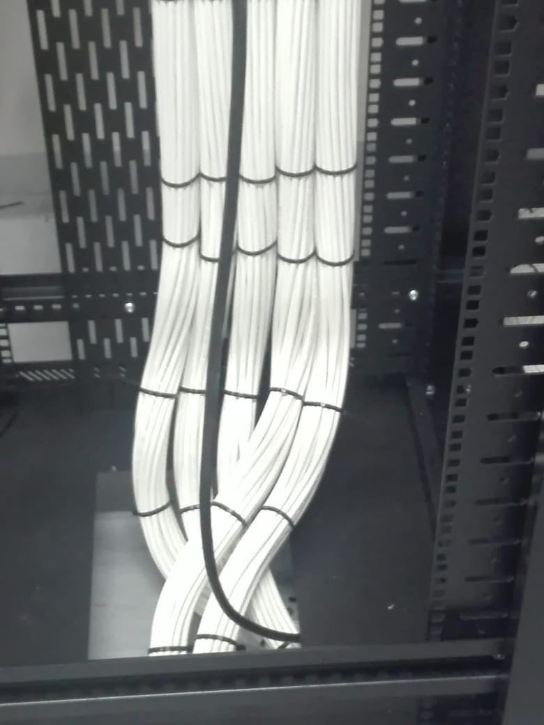 Cat6 cable bundles combed and tied, entering the rack from below